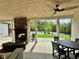 This covered patio features a fireplace, outdoor dining, and a view of the pool at 16 Mountain Creek Ne Trl, Fairmount, GA 30139