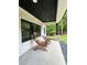Relaxing covered porch with stone pillars and wooden chairs, overlooking the landscaped backyard at 16 Mountain Creek Ne Trl, Fairmount, GA 30139