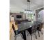 Open floor plan featuring a dining room with modern table and chairs and exposed brick arches at 16 Mountain Creek Ne Trl, Fairmount, GA 30139