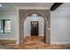 Inviting entryway featuring a brick archway, wood floors, and a stylish front door at 16 Mountain Creek Ne Trl, Fairmount, GA 30139