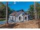 Side exterior view of home with large garage and manicured lawn surrounded by trees at 16 Mountain Creek Ne Trl, Fairmount, GA 30139