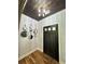 Entryway featuring hardwood floors, a stylish light fixture, and decorative mirrors leading to the front door at 16 Mountain Creek Ne Trl, Fairmount, GA 30139