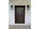 Close up of the front door, featuring a custom knocker, sidelights, and white brick surround at 16 Mountain Creek Ne Trl, Fairmount, GA 30139