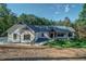 Charming white brick home with black accents, well-manicured lawn and covered porch at 16 Mountain Creek Ne Trl, Fairmount, GA 30139