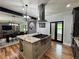 Open-concept kitchen with a central island, stainless steel appliances, and connection to the dining area at 16 Mountain Creek Ne Trl, Fairmount, GA 30139