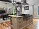 Modern kitchen with a large island, granite countertops, and a stainless steel range hood at 16 Mountain Creek Ne Trl, Fairmount, GA 30139