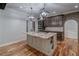 Open-concept kitchen featuring a large island with stainless steel appliances and granite countertops at 16 Mountain Creek Ne Trl, Fairmount, GA 30139