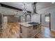 Bright kitchen featuring a large island with cooktop and stainless steel range hood at 16 Mountain Creek Ne Trl, Fairmount, GA 30139