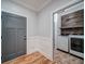 Charming laundry room with wainscoting, decorative wall, and new washer and dryer at 16 Mountain Creek Ne Trl, Fairmount, GA 30139
