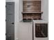 The laundry room has a wood accent wall, floating shelf and new matching, high-end washer and dryer at 16 Mountain Creek Ne Trl, Fairmount, GA 30139