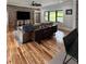 Comfortable living room area, featuring wood floors, brick accent wall, and natural light at 16 Mountain Creek Ne Trl, Fairmount, GA 30139