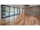 Open living room boasts brick wall, sliding glass doors, and backyard patio at 16 Mountain Creek Ne Trl, Fairmount, GA 30139