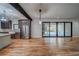 Open living room features stainless refrigerator, dark wood accents, and sliding glass doors at 16 Mountain Creek Ne Trl, Fairmount, GA 30139