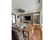 Bright living room featuring wood floors, brick wall, and a ceiling fan at 16 Mountain Creek Ne Trl, Fairmount, GA 30139