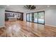 Open living room features island kitchen, stainless refrigerator, sliding glass doors, and backyard at 16 Mountain Creek Ne Trl, Fairmount, GA 30139