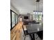 Open-concept dining and living areas with wood floors and brick accents at 16 Mountain Creek Ne Trl, Fairmount, GA 30139