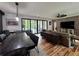 Open-concept living room with dining area, featuring access to an outdoor living space via sliding glass doors at 16 Mountain Creek Ne Trl, Fairmount, GA 30139