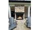 An outdoor stone fireplace adds warmth and elegance to the covered patio space at 16 Mountain Creek Ne Trl, Fairmount, GA 30139