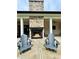 An outdoor stone fireplace adds warmth and elegance to the covered patio space at 16 Mountain Creek Ne Trl, Fairmount, GA 30139