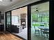 Sliding glass door view onto an outdoor patio with fireplace and dining, and in-ground pool at 16 Mountain Creek Ne Trl, Fairmount, GA 30139