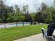Backyard swimming pool with lounge chairs surrounded by a black fence and lush landscaping at 16 Mountain Creek Ne Trl, Fairmount, GA 30139
