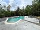 A kidney-shaped pool with water features offers a refreshing backyard oasis with a concrete patio at 16 Mountain Creek Ne Trl, Fairmount, GA 30139