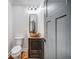 This powder room features hardwood floors, a decorative sink, and modern lighting at 16 Mountain Creek Ne Trl, Fairmount, GA 30139