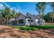 Landscaped backyard with lawn and privacy fence showcasing the home's modern architectural design and setting at 16 Mountain Creek Ne Trl, Fairmount, GA 30139