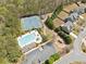 Community aerial view featuring two tennis courts, a playground, pool, and well-maintained homes in a wooded area at 2710 Irwin Ct, Cumming, GA 30041