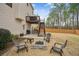 Private backyard featuring a stone fire pit, a seating area, and a second-story deck, perfect for entertaining at 2710 Irwin Ct, Cumming, GA 30041