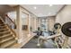 Basement gym area with weight-lifting equipment and adjacent staircase at 2710 Irwin Ct, Cumming, GA 30041