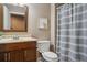 Bathroom with vanity, toilet, and shower featuring a striped curtain at 2710 Irwin Ct, Cumming, GA 30041