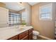 Bathroom with a window, granite vanity, and shower-tub combo with stylish curtain at 2710 Irwin Ct, Cumming, GA 30041