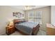 Bedroom featuring wall art, ceiling fan, and window overlooking the backyard at 2710 Irwin Ct, Cumming, GA 30041