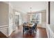 Bright dining room featuring hardwood floors, wainscoting, and a modern chandelier, ideal for Gathering gatherings at 2710 Irwin Ct, Cumming, GA 30041
