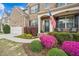 Close-up of a charming home featuring colorful landscaping, an American flag and a welcoming entrance at 2710 Irwin Ct, Cumming, GA 30041