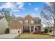 Charming brick home featuring a well-manicured lawn and a cozy front porch, perfect for relaxing at 2710 Irwin Ct, Cumming, GA 30041