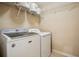 Bright laundry room with Maytag washer and dryer and storage shelves at 2710 Irwin Ct, Cumming, GA 30041