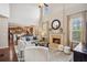 Bright and airy living room with fireplace, soaring ceilings, and view into the modern kitchen at 2710 Irwin Ct, Cumming, GA 30041