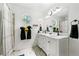 Bright bathroom with a double sink vanity, marble countertops, and a unique octagonal window at 507 Lakeshore Dr, Stockbridge, GA 30281