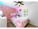 Bright bedroom featuring vibrant decor, playful lighting, and a ceiling fan at 507 Lakeshore Dr, Stockbridge, GA 30281