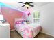 Whimsical bedroom featuring a colorful bedspread, bright accents, and a ceiling fan at 507 Lakeshore Dr, Stockbridge, GA 30281