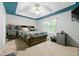 Spacious bedroom featuring a tray ceiling, large bed with storage, and natural light at 507 Lakeshore Dr, Stockbridge, GA 30281