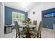 Dining room featuring modern lighting, a table set for four, and blue accent wall at 507 Lakeshore Dr, Stockbridge, GA 30281