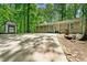 Front view of home featuring a storage shed, surrounded by mature trees and nature at 507 Lakeshore Dr, Stockbridge, GA 30281