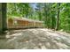 View of the home with siding, covered porch, surrounded by large mature trees at 507 Lakeshore Dr, Stockbridge, GA 30281