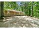 Exterior view of home and spacious front yard surrounded by natural landscape at 507 Lakeshore Dr, Stockbridge, GA 30281