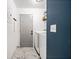 Functional laundry area with washer, dryer, tiled floors, and storage shelf for convenience at 507 Lakeshore Dr, Stockbridge, GA 30281