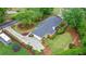 Aerial perspective of the home exhibiting its neatly manicured lawn, driveway, mature landscaping, and deck at 1405 Murdock Rd, Marietta, GA 30062
