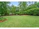 A spacious backyard featuring green grass and mature trees at 1405 Murdock Rd, Marietta, GA 30062